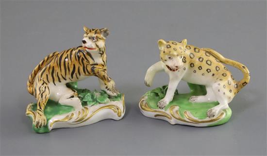 A pair of Derby porcelain figures of a tiger and a leopard, c. 1820-30, L. 5.8cm - 6.7cm, restorations
